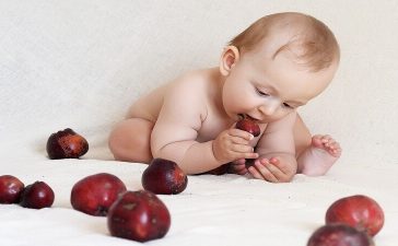 baby eating fruit