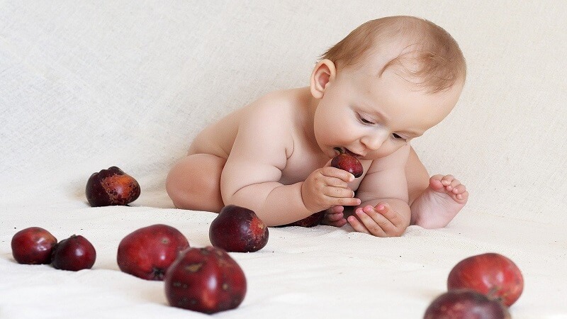 baby eating fruit