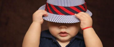 baby with blue cap