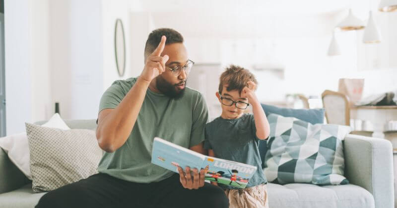 boy reading with dad
