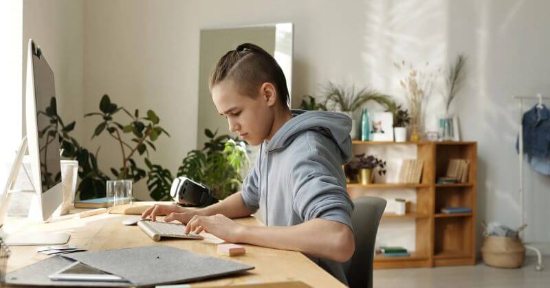 Boy Studying In Grey Hoodie