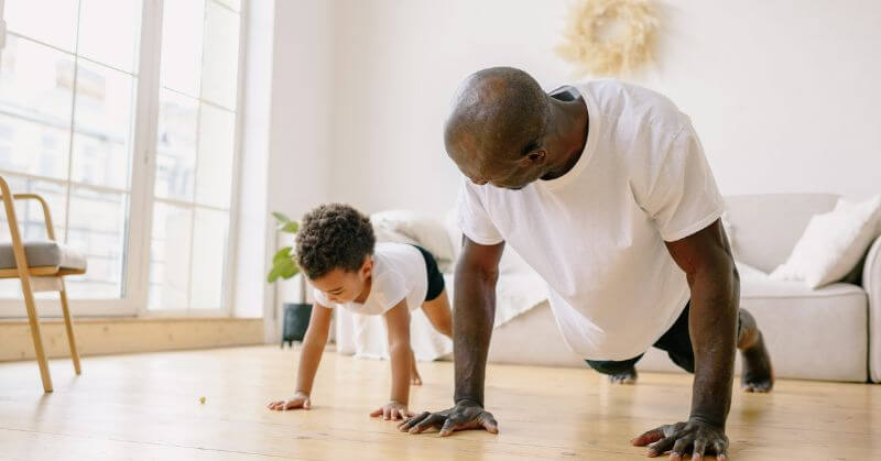 kid exercising with dad