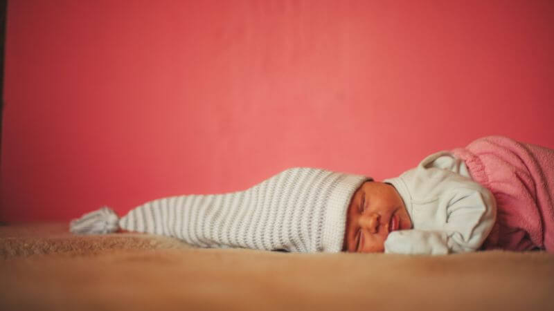 Cute baby with big cap