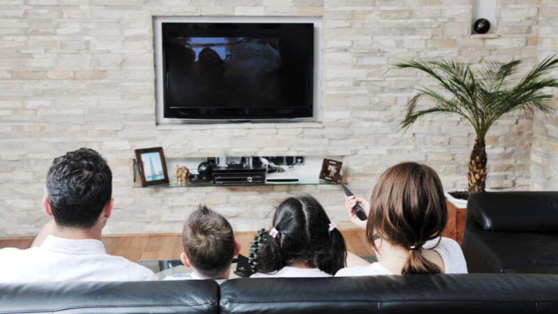 Family watching tv together