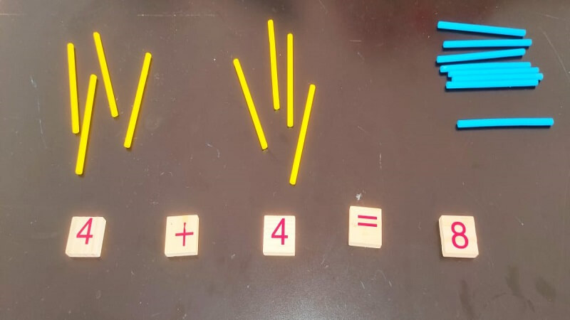 With wooden sticks and numbers